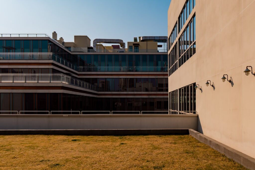 Modern building with vertical dark panels and windows.