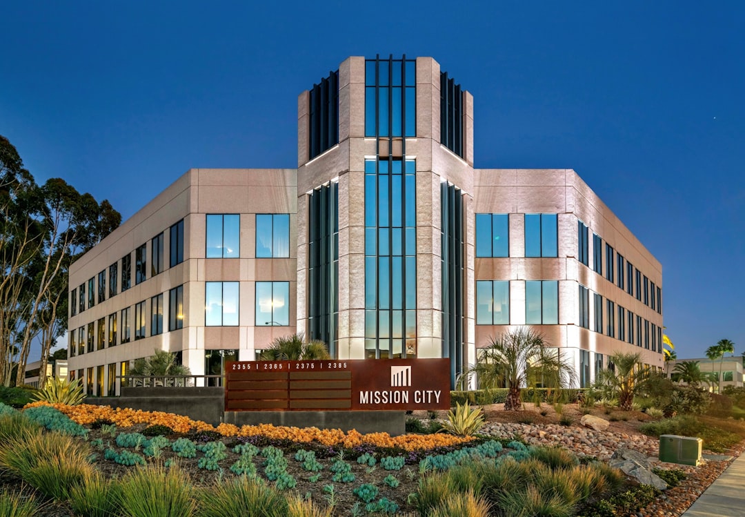 Modern glass buildings against a clear blue sky