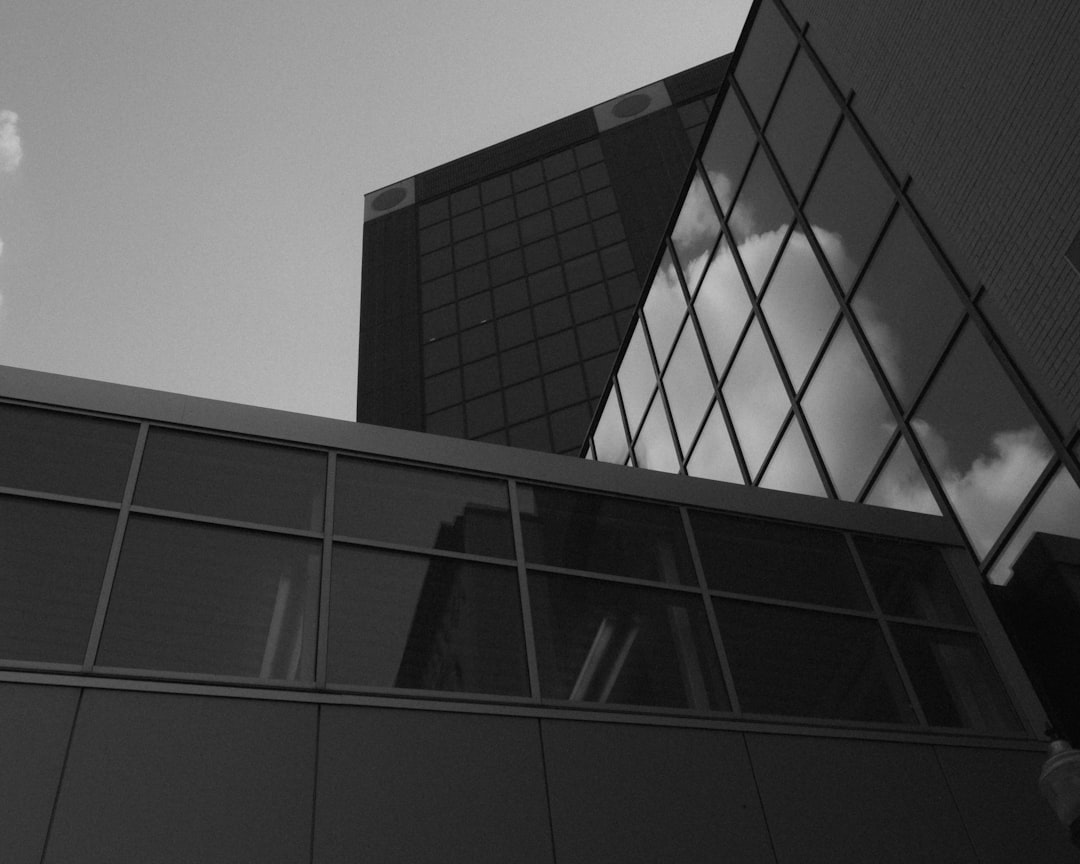 Modern apartment building with balconies and greenery.