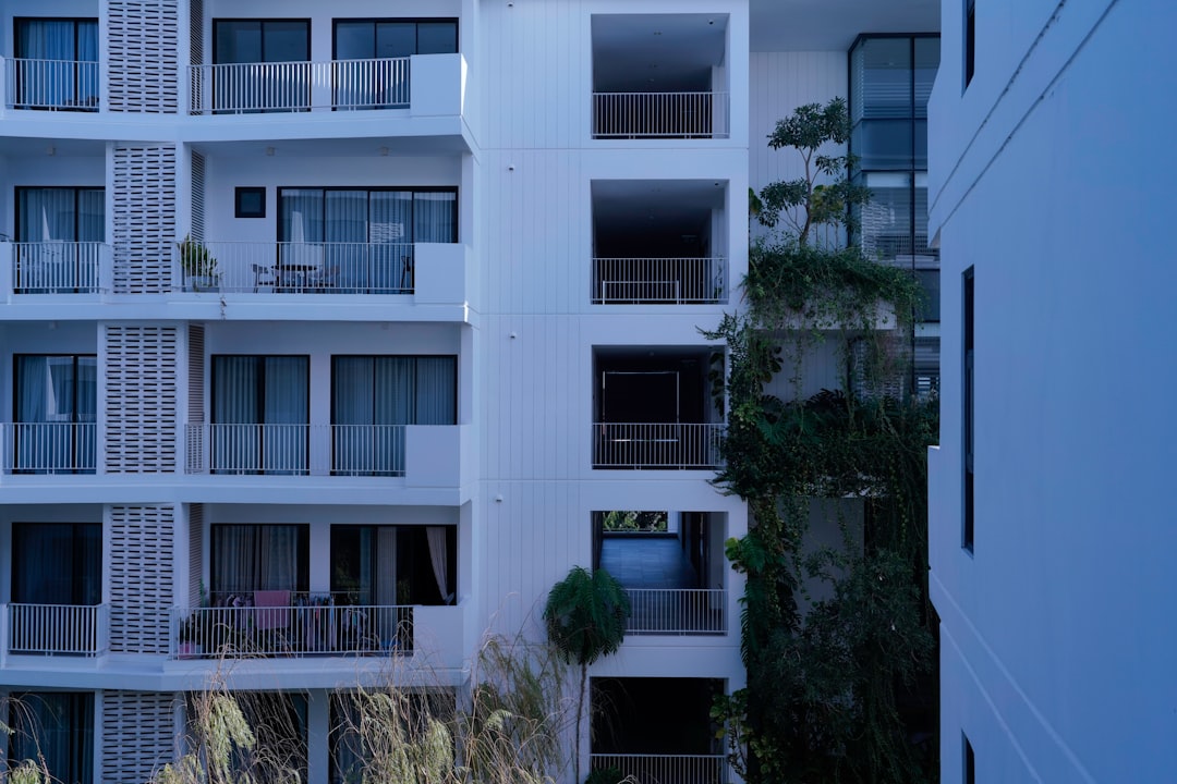 Modern building with a green lawn and trees.