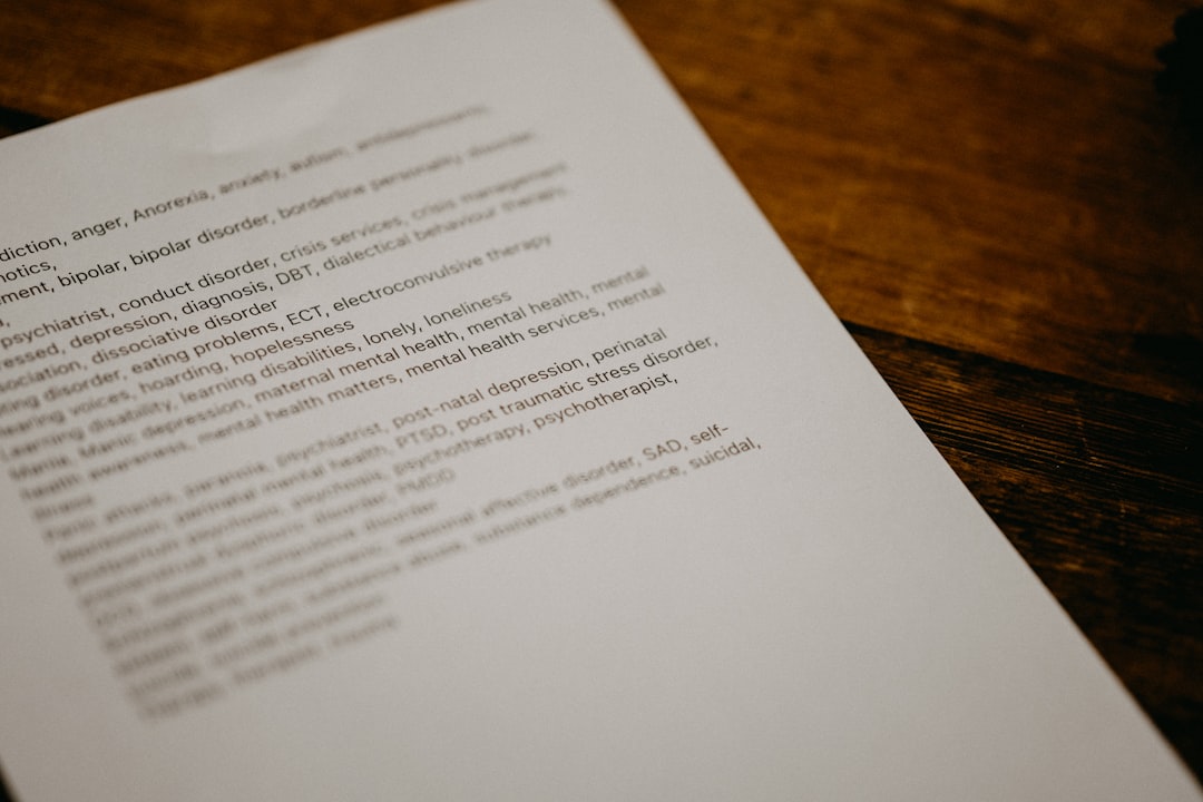 person writing on brown wooden table