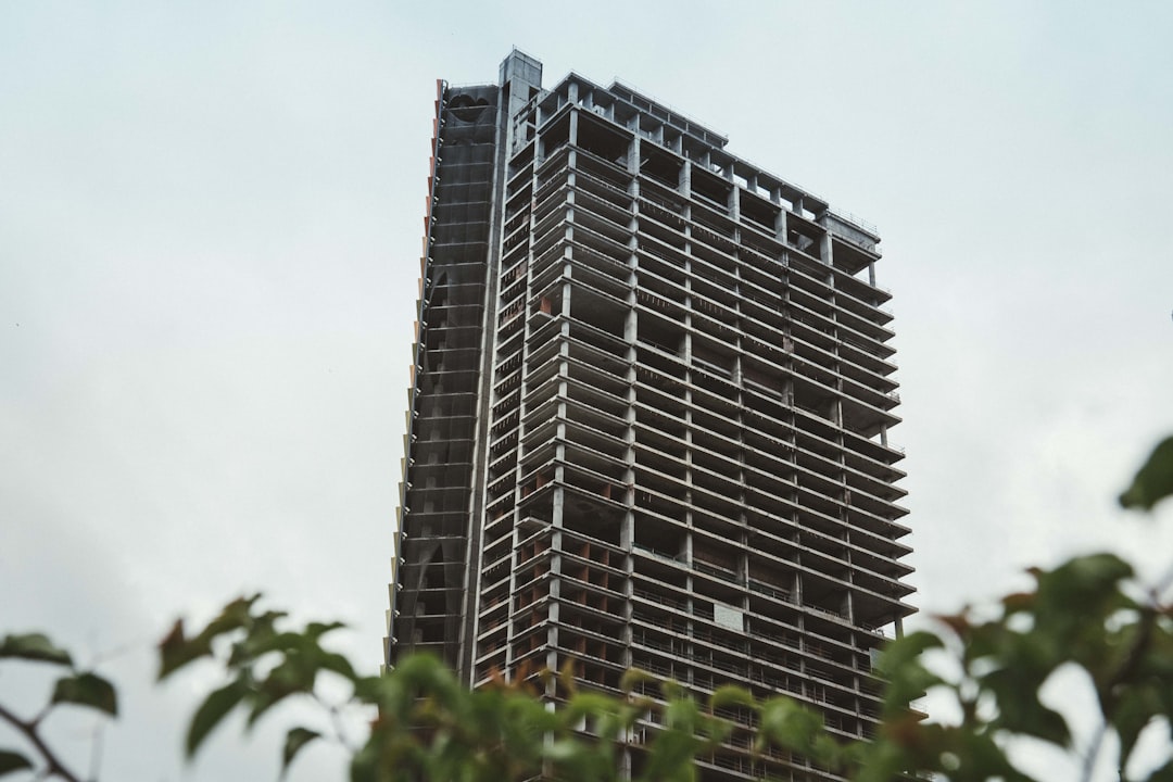 Modern building with curved facade against blue sky