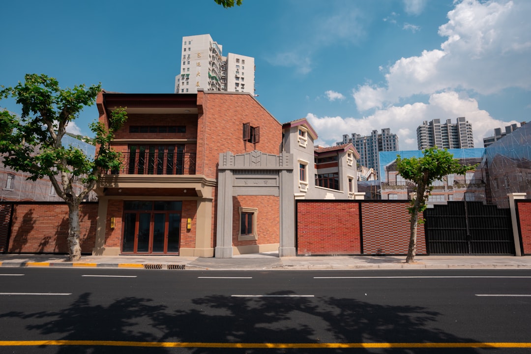 Brick building with windows against a clear blue sky.